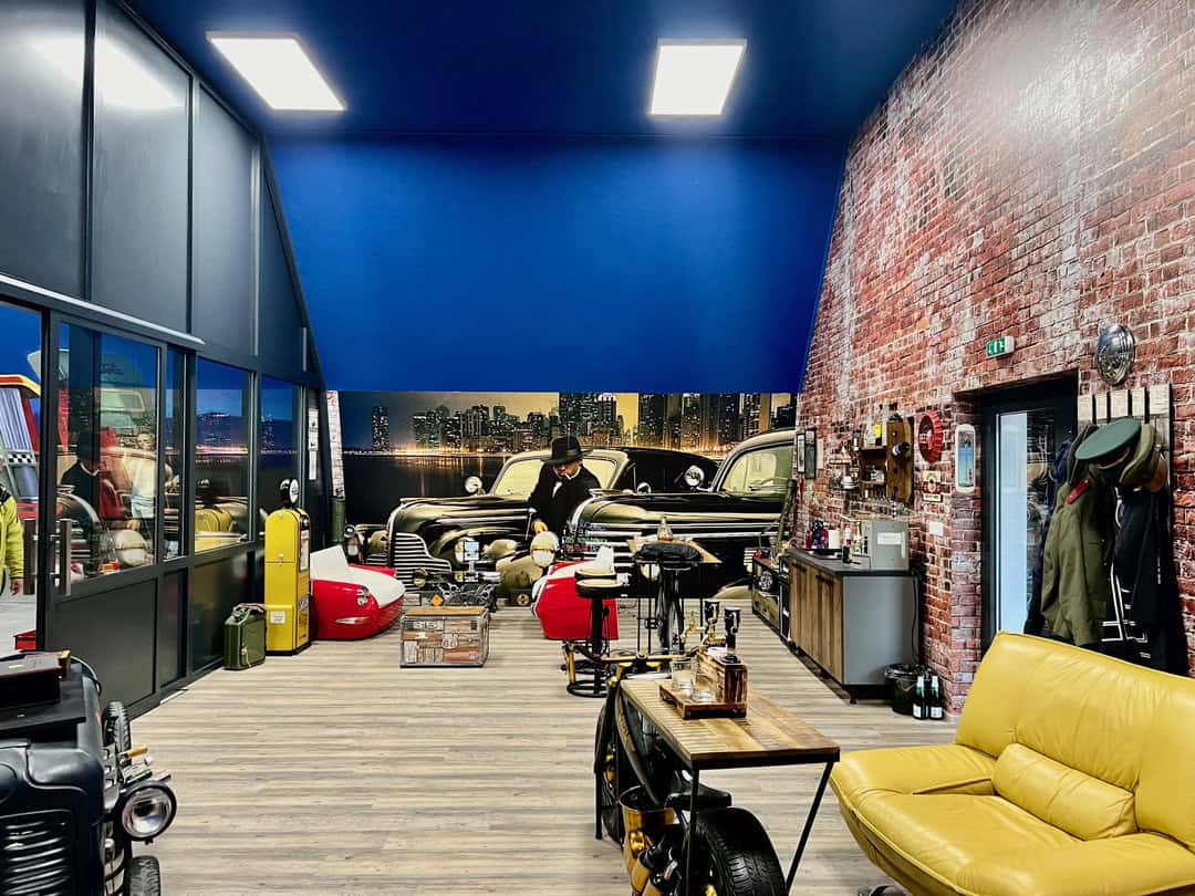 Stylový interiér soukromého muzea automobilů s retro atmosférou v obloukové montované ocelové hale realizované společností HUPRO SYSTEMS SE.