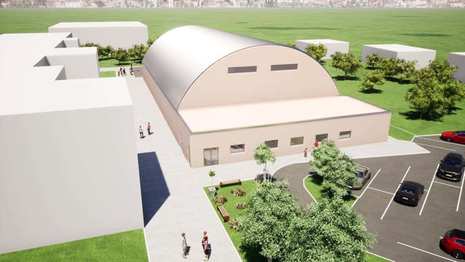 Oblouková sportovní hala Koprivnica, vizualizace exteriéru s moderním obloukovým opláštěním, parkovištěm a přilehlými zelenými plochami, realizace HUPRO SYSTEMS SE.